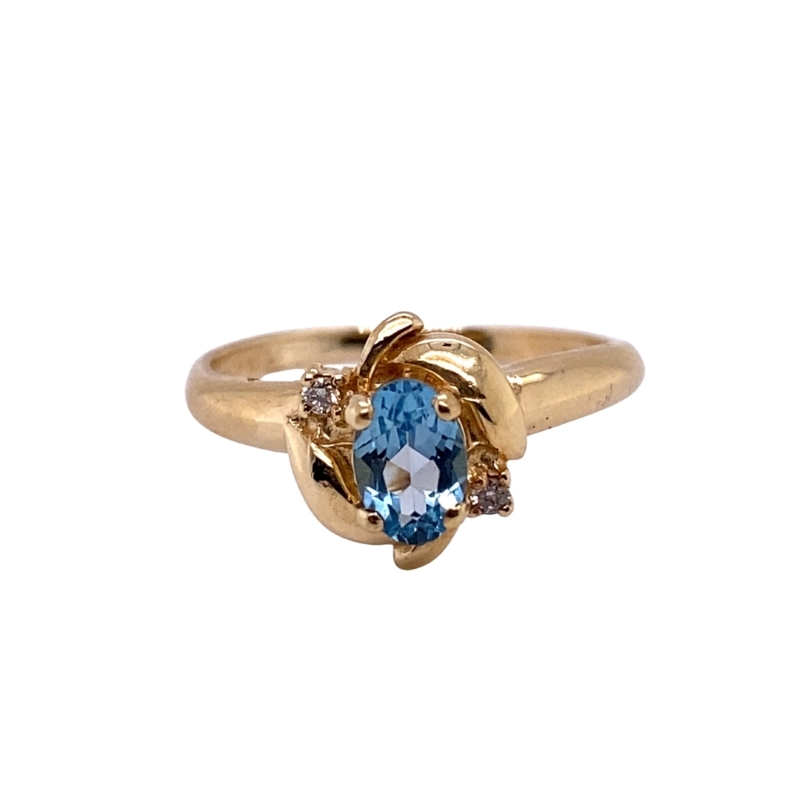 a gold ring with a blue stone and diamonds
