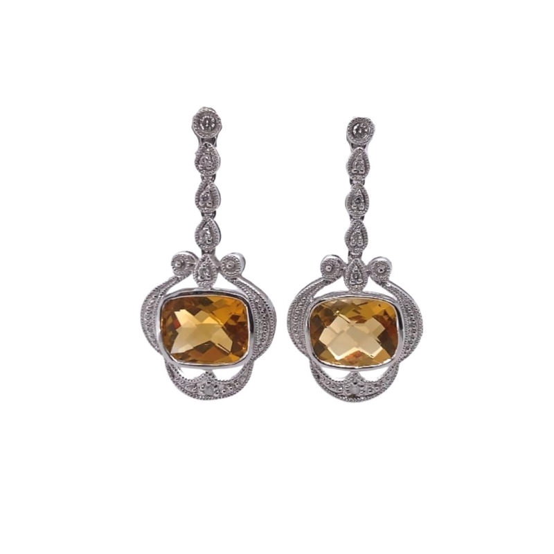 a pair of earrings with yellow stones and diamonds