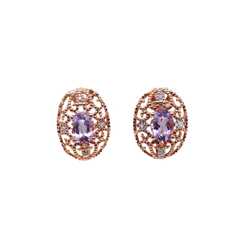 a pair of earrings with purple stones and diamonds