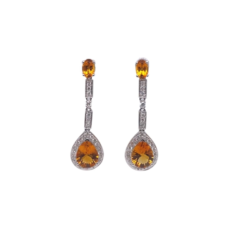 a pair of earrings with orange and white stones