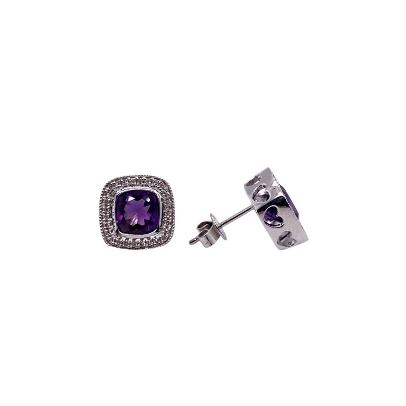 a pair of earrings with purple stones on them