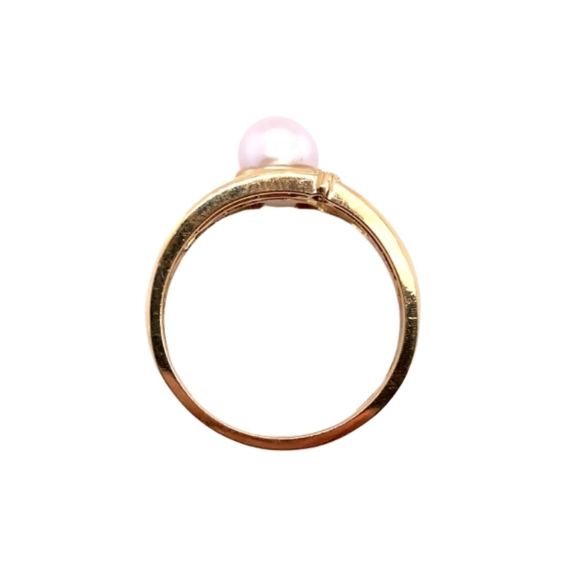 a gold ring with a pearl on top