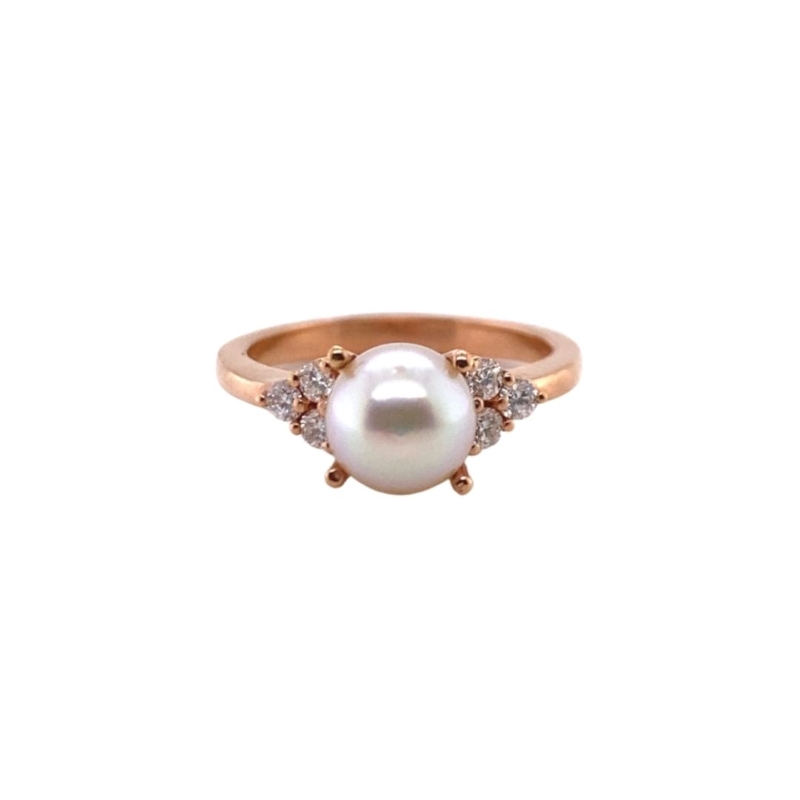 a pearl and diamond ring on a white background