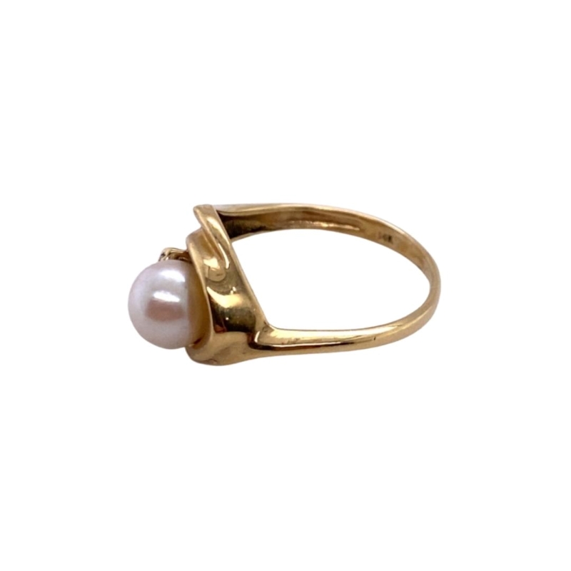 a gold ring with a white pearl