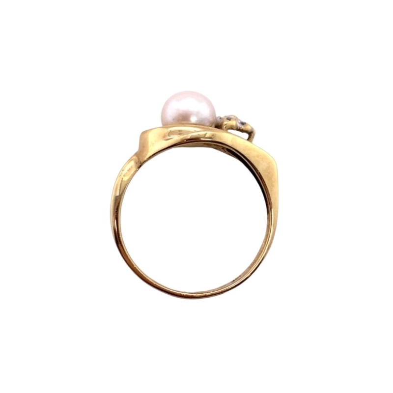 a gold ring with two pearls on it