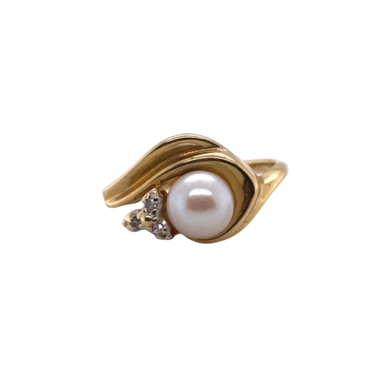 a gold ring with a pearl and two diamonds