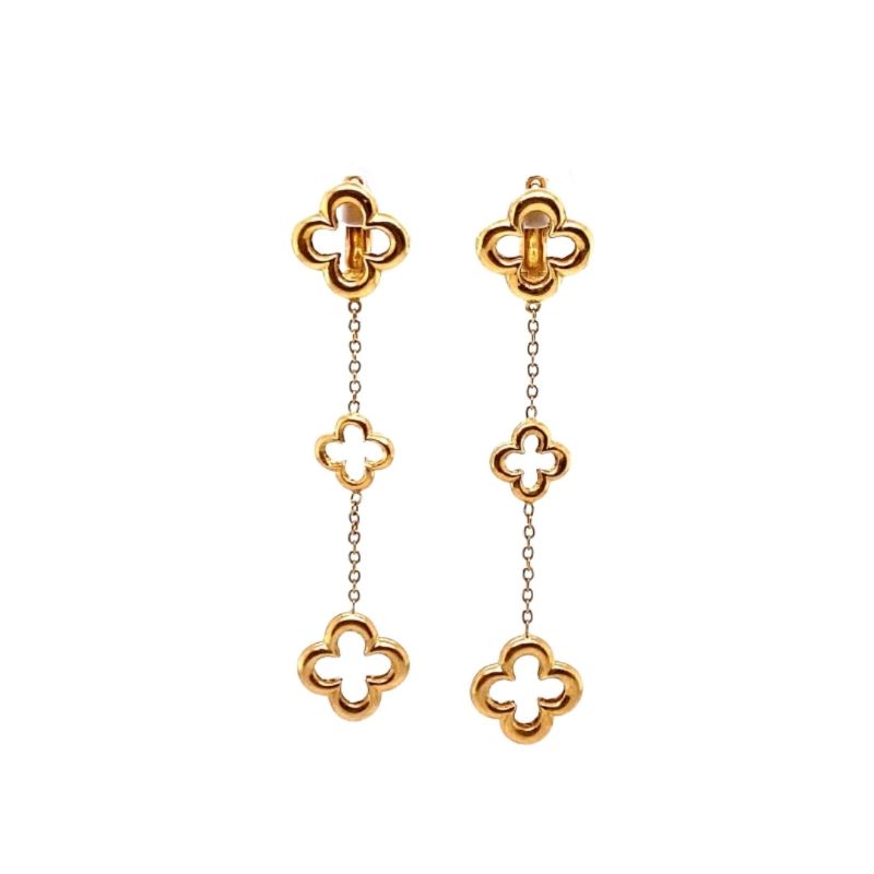 a pair of gold earrings with clover links
