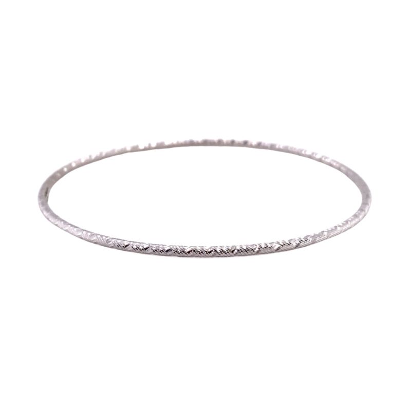 a thin silver bang bracelet on a white background