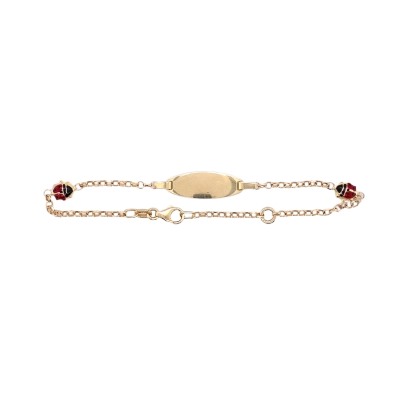 a gold bracelet with two red stones on it