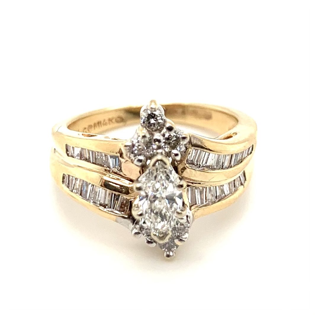 a yellow gold ring with two diamonds on it