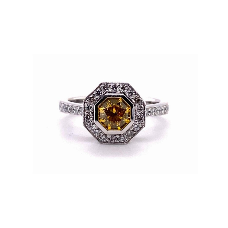 a ring with a yellow diamond in the center