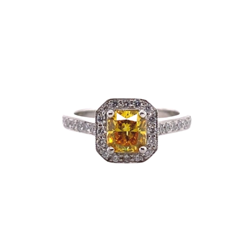 a yellow and white diamond ring on a white background