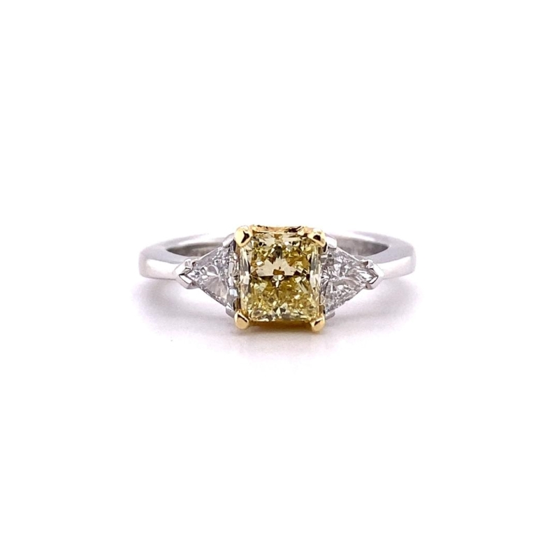 a fancy yellow diamond ring with three diamonds