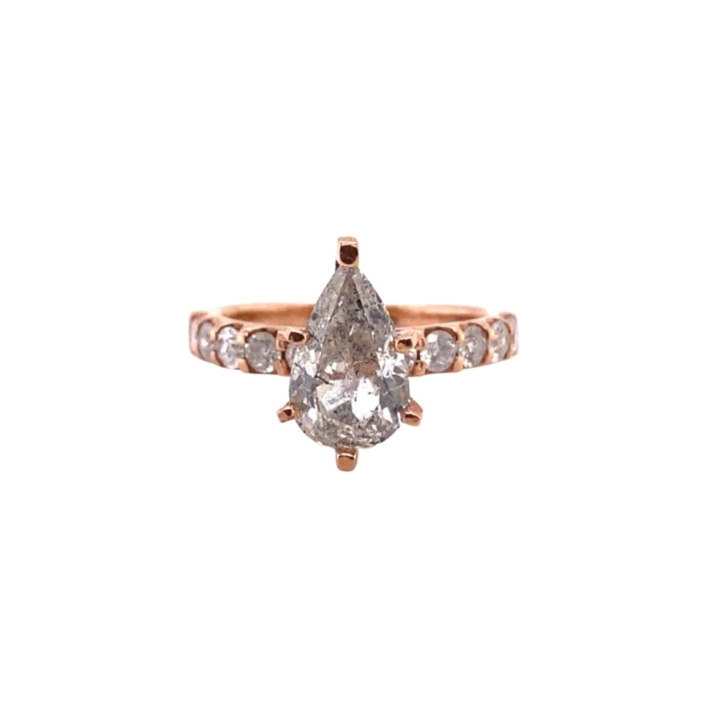 a rose gold ring with a pear shaped diamond