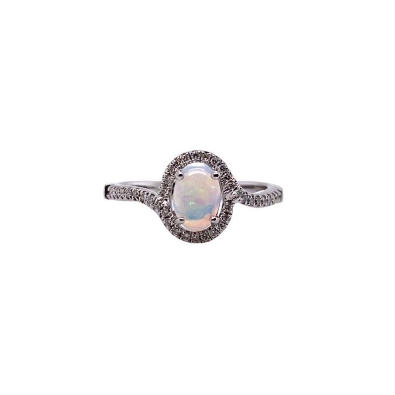 a white opal and diamond ring on a white background