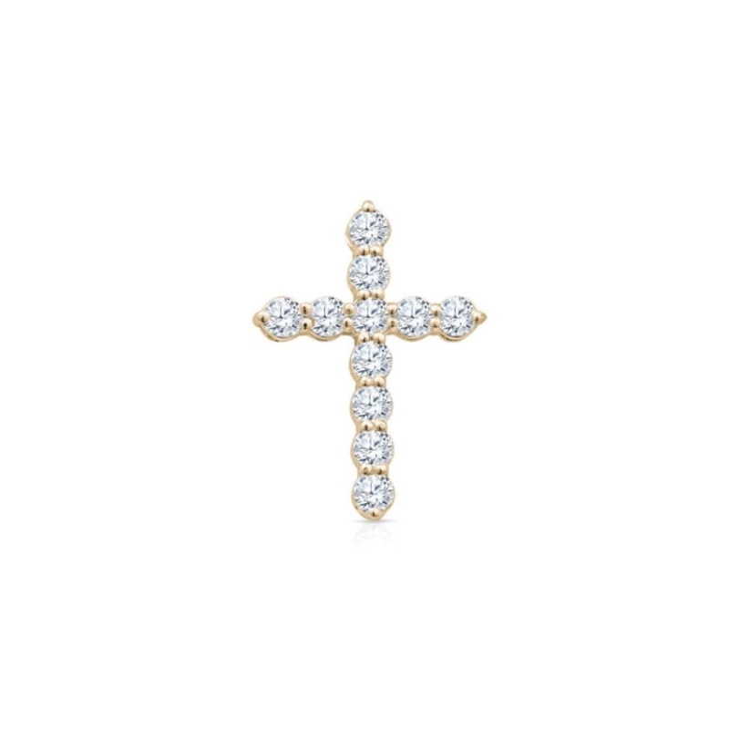 a gold cross pendant with white stones