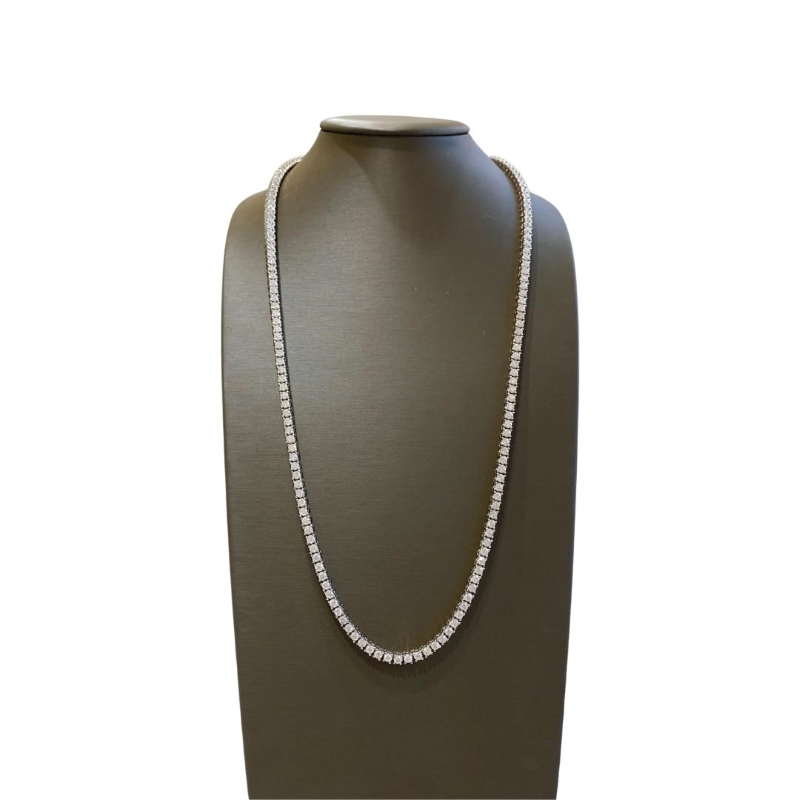 a white necklace on a mannequin