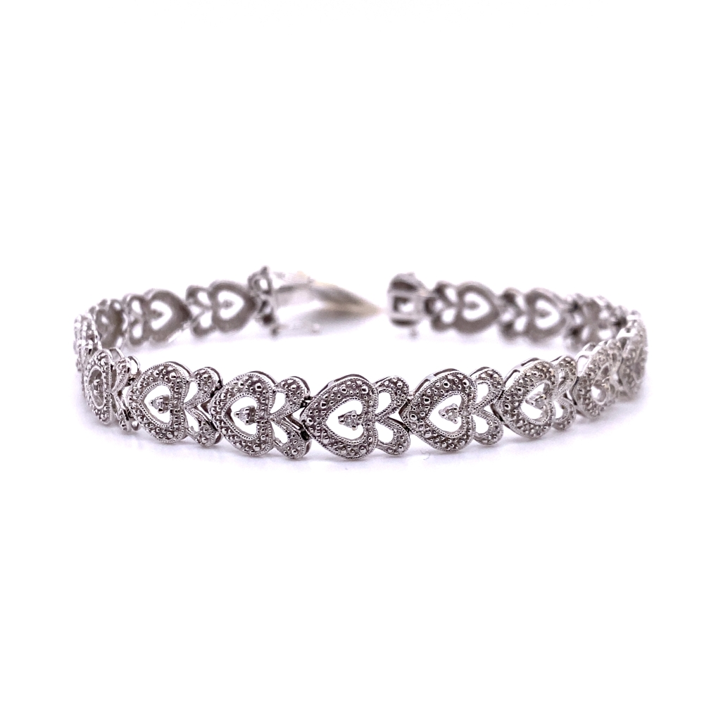 a silver bracelet with hearts on it