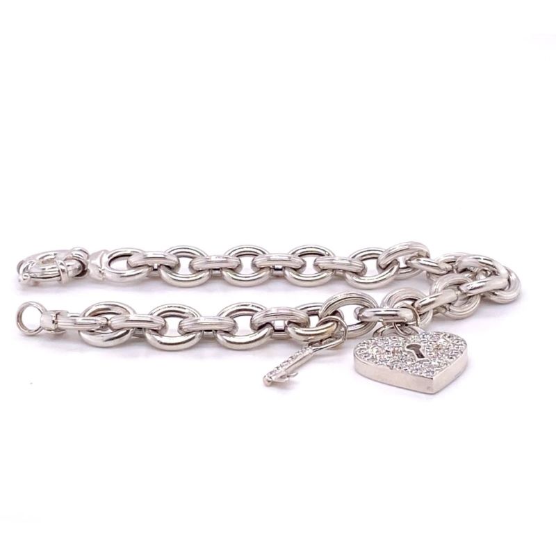 a silver bracelet with a heart charm on it