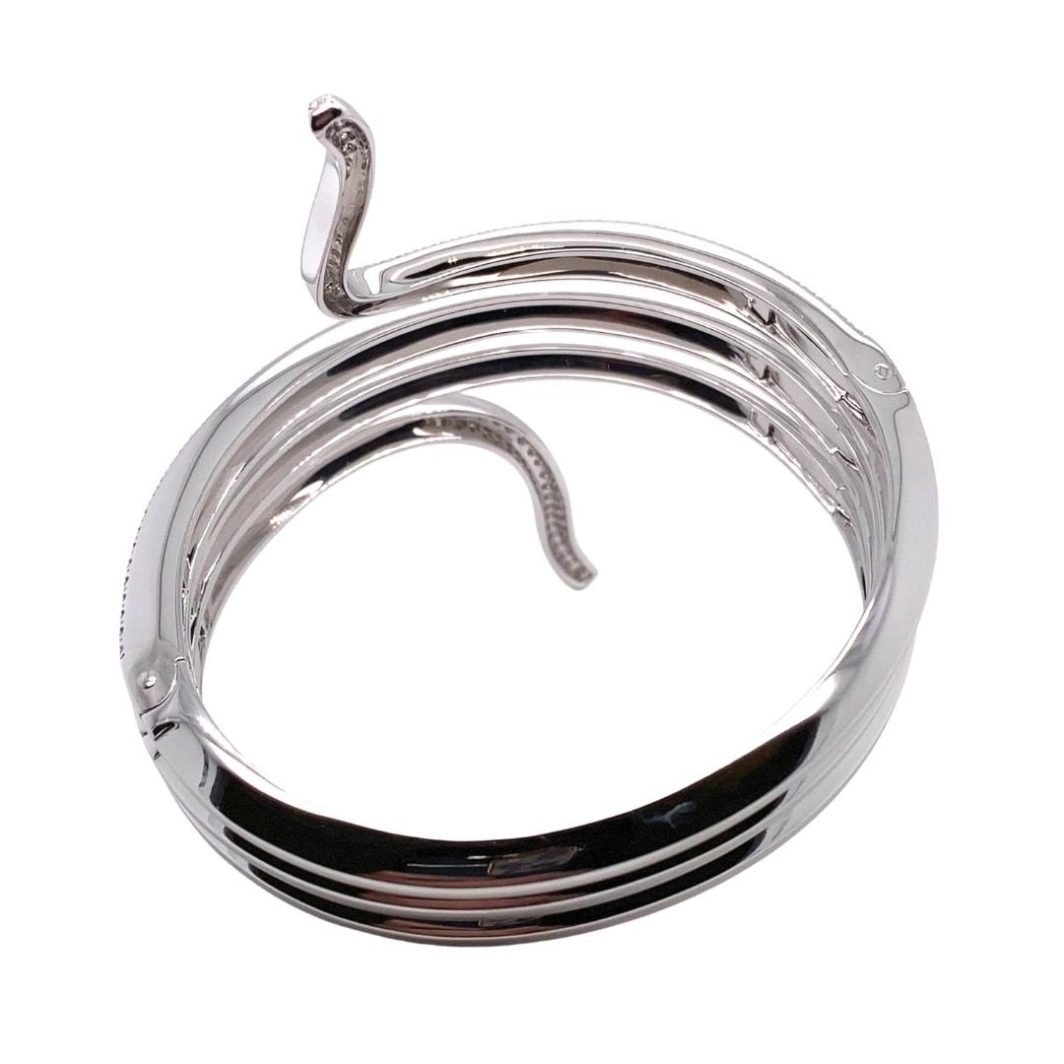 a silver snake ring on a white background