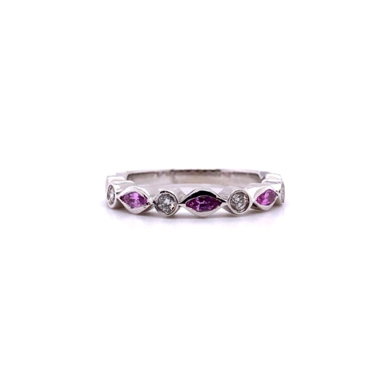 a white gold ring with three purple stones
