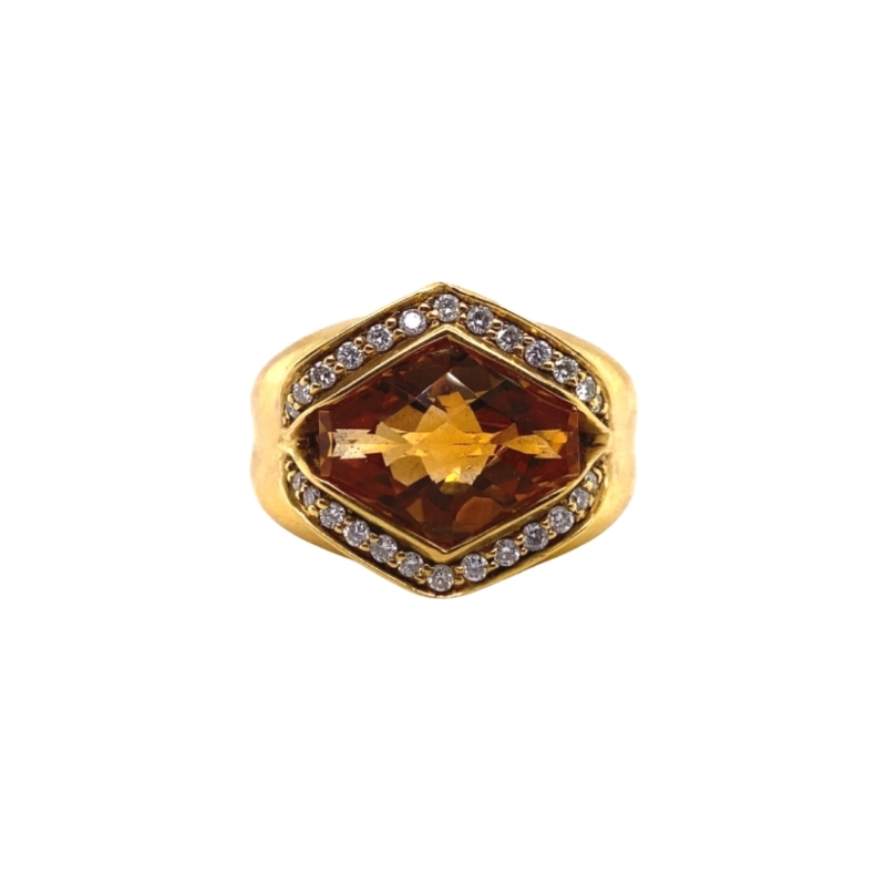 a gold ring with an orange stone and diamonds