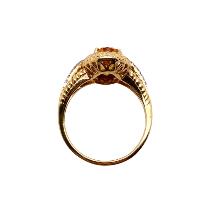 a gold ring with an orange stone in the center