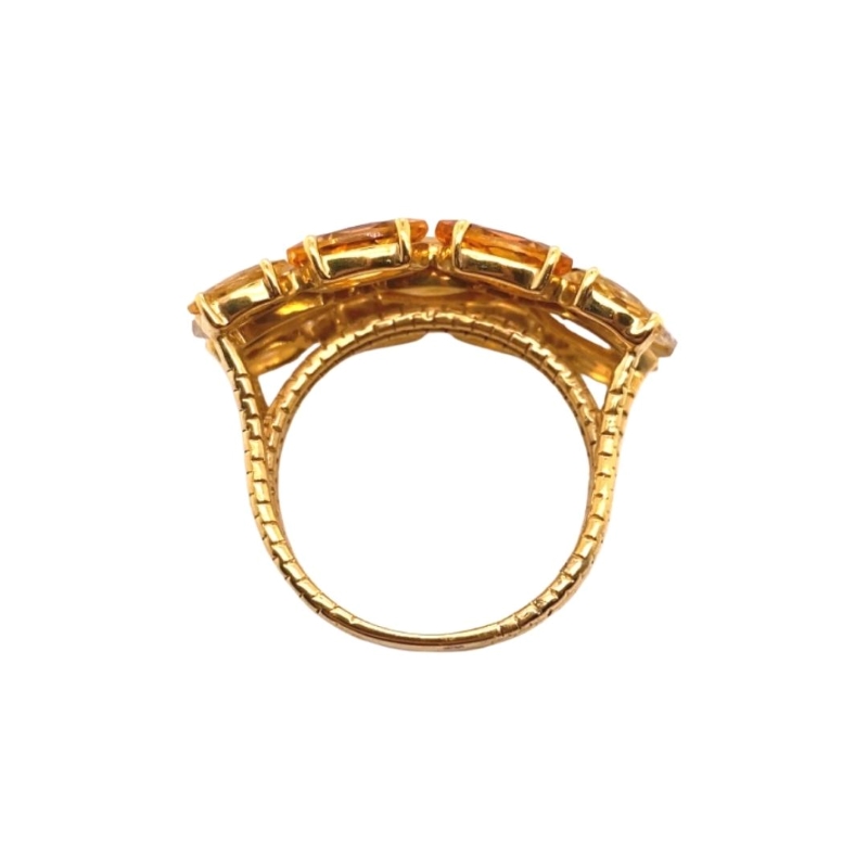 a gold ring with five stones on it