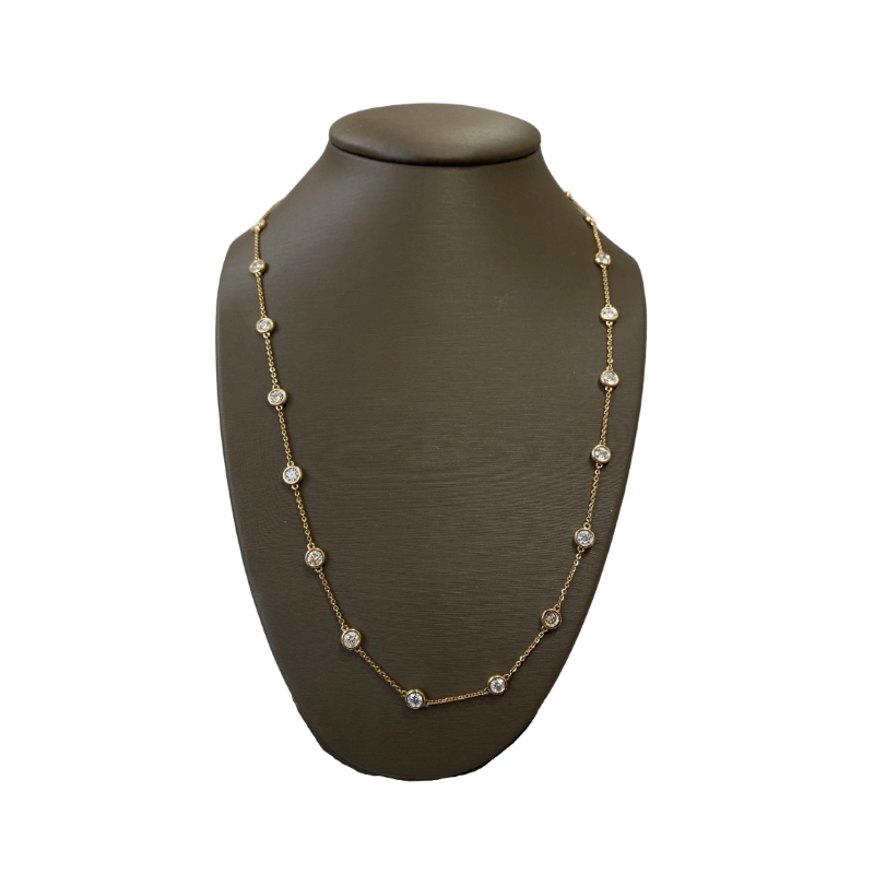 a necklace on a mannequin with white stones