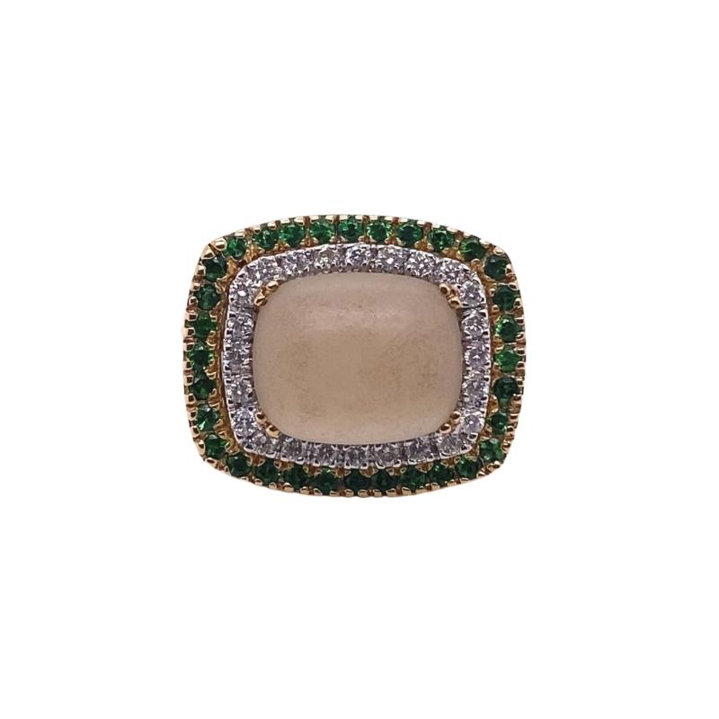a ring with green and white stones on it