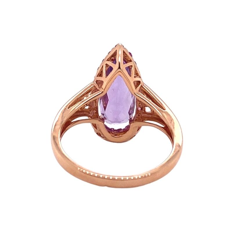 an 18 karat rose gold ring set with a pear shaped amethoraite