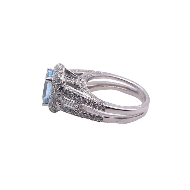 a white gold ring with an aqua topazte and diamonds