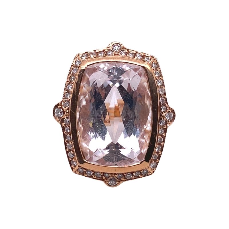 a ring with a large pink stone surrounded by diamonds