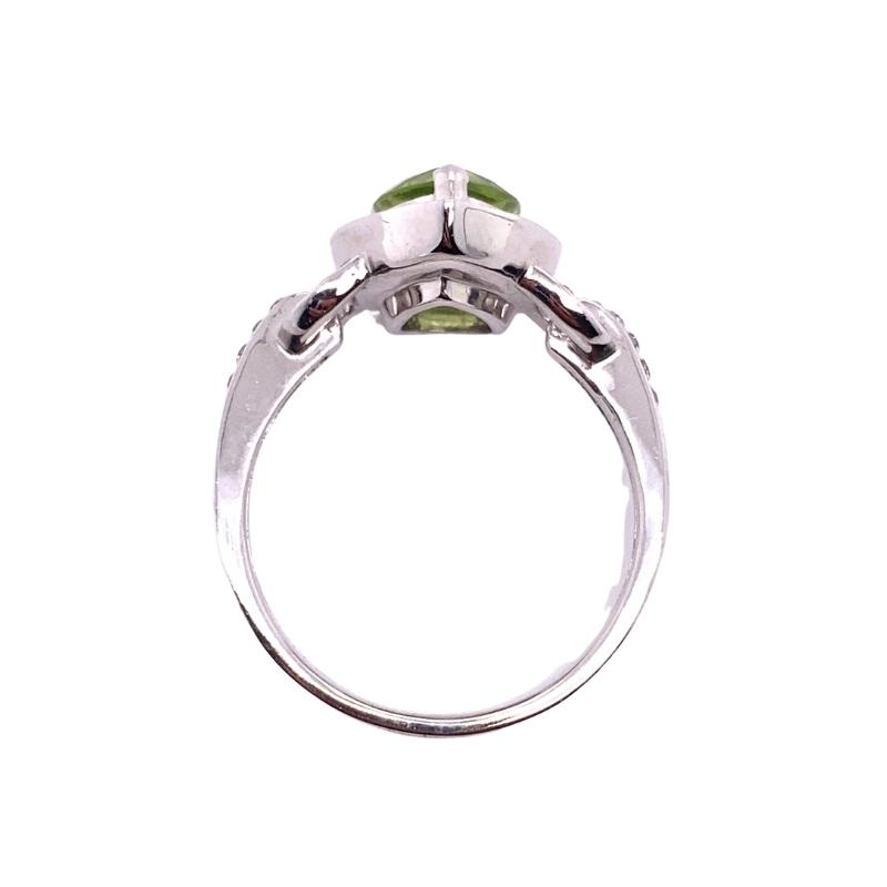 a ring with a green stone in the center