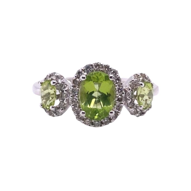three stone ring with green and white stones