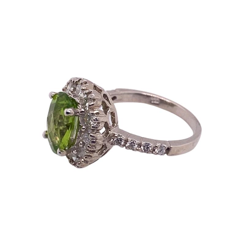 a ring with a green stone and white diamonds