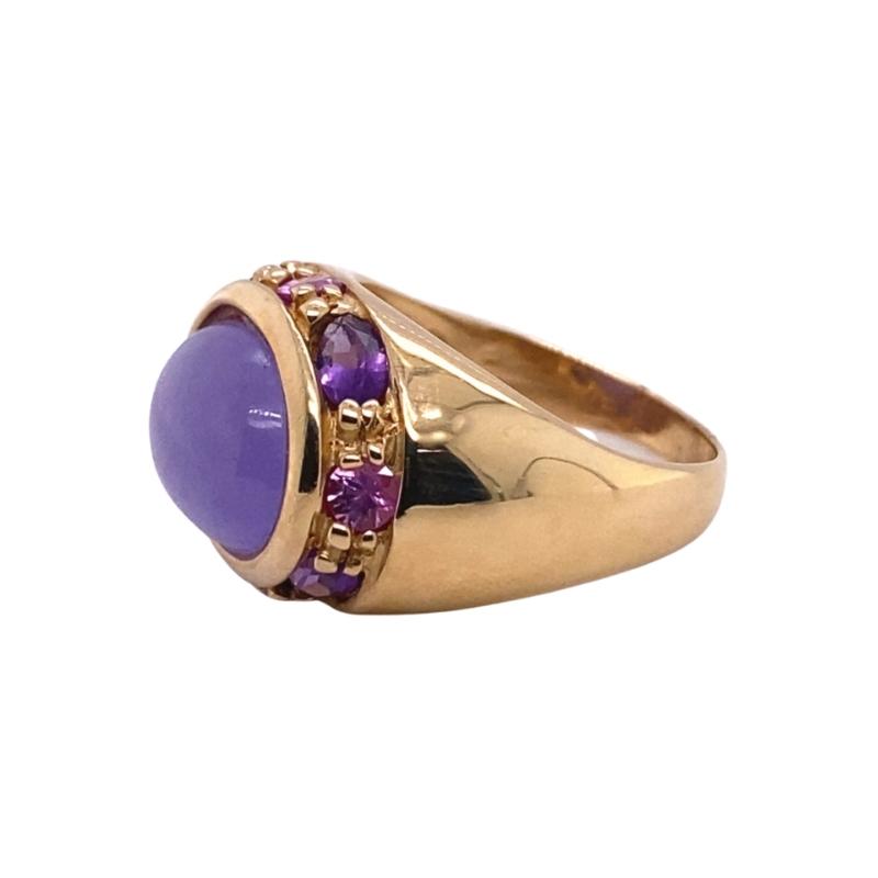a gold ring with purple stones on it