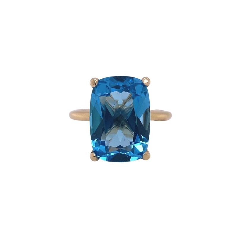 a blue topazte ring with two gold accents