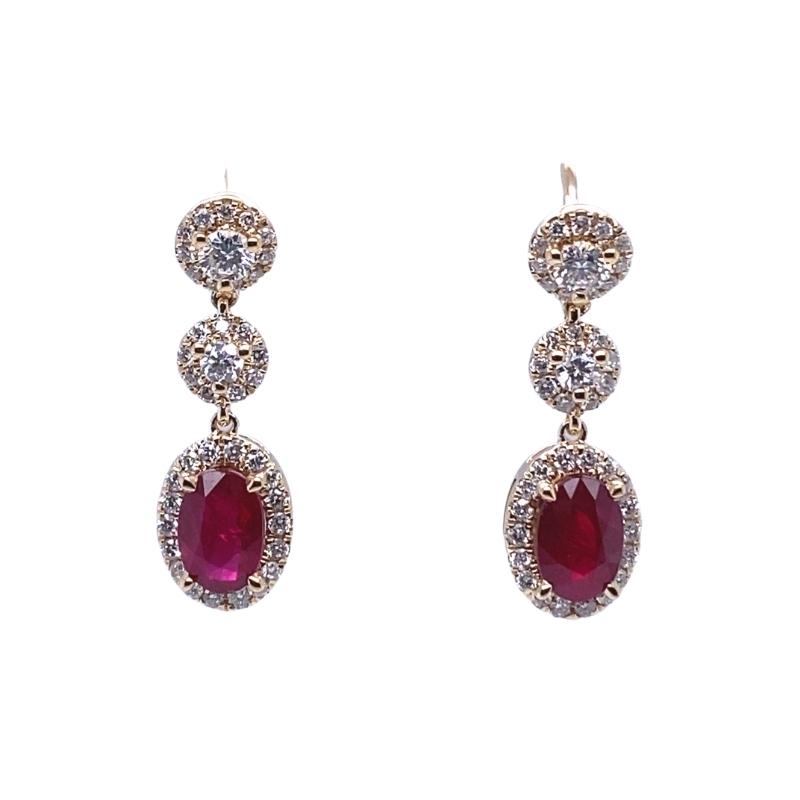 a pair of earrings with diamonds and red stones