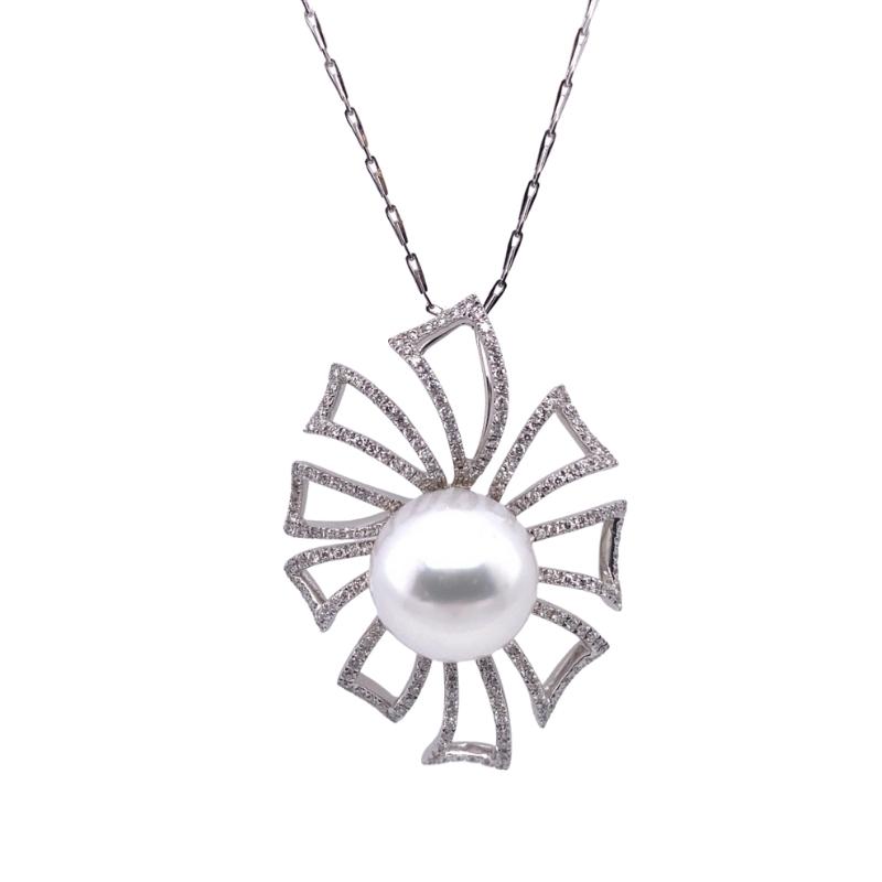 a white pearl and diamond pendant on a chain