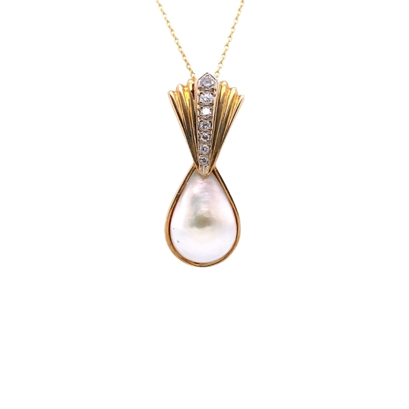 a gold necklace with a white pearl and diamonds