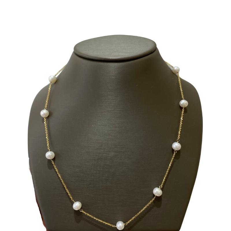a necklace with pearls on a mannequin