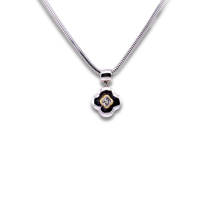 a black and white flower pendant on a silver chain
