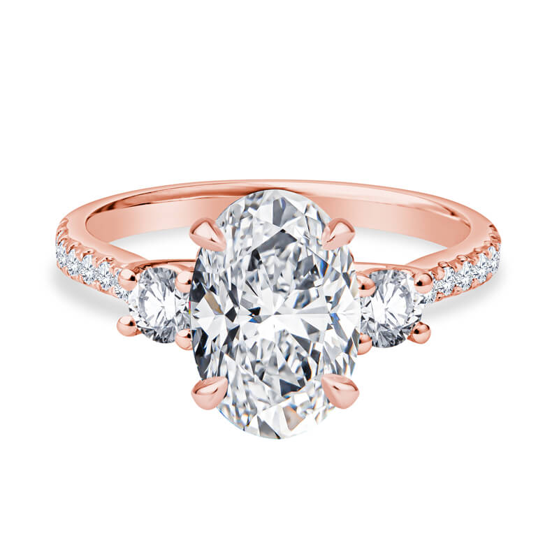 a rose gold engagement ring with three stones