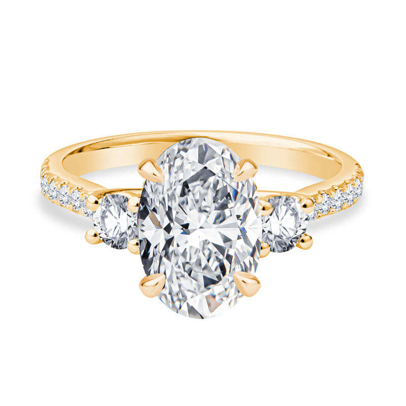 a yellow gold engagement ring with three stones