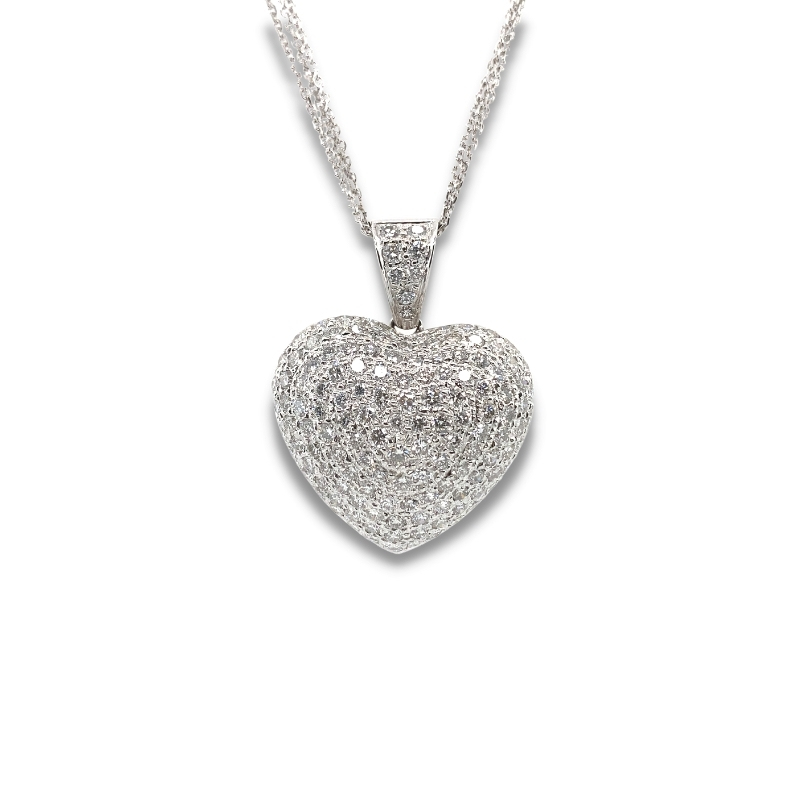 a heart shaped pendant with diamonds on a chain