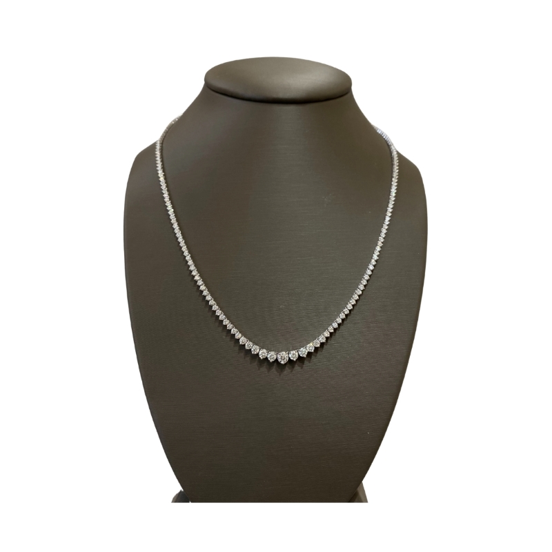 a necklace on a mannequin with a white background