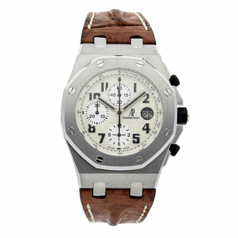 a watch with a white dial and brown leather strap