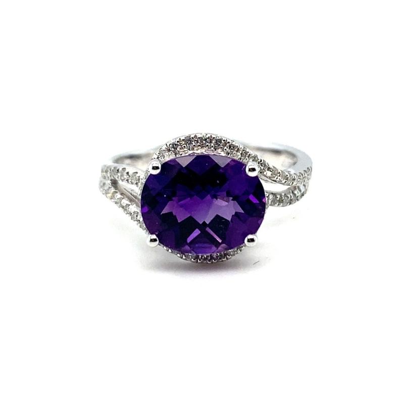 a ring with a large purple stone surrounded by diamonds