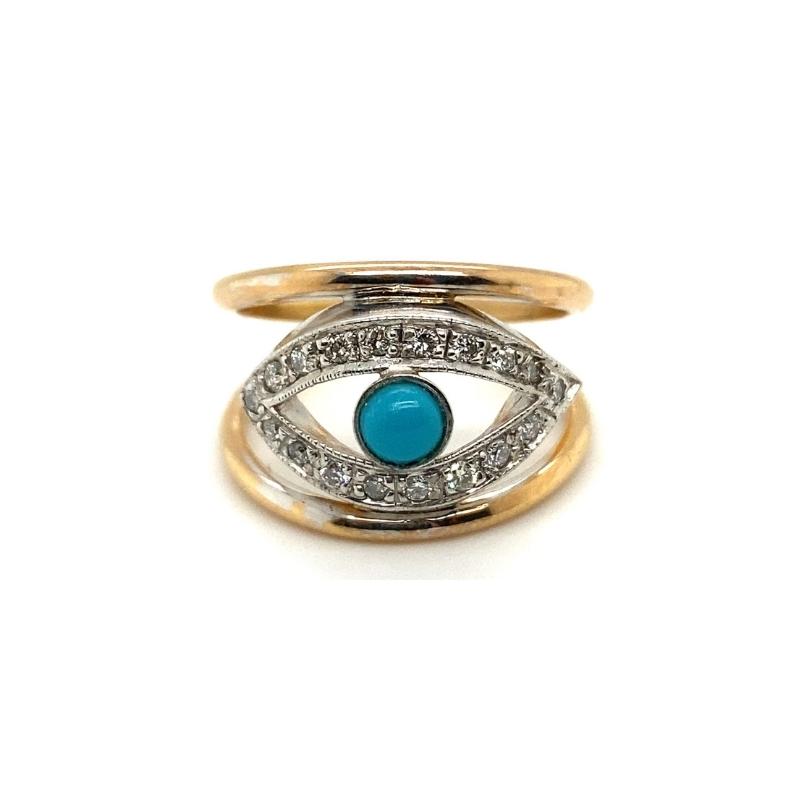 a gold and silver ring with an evil eye